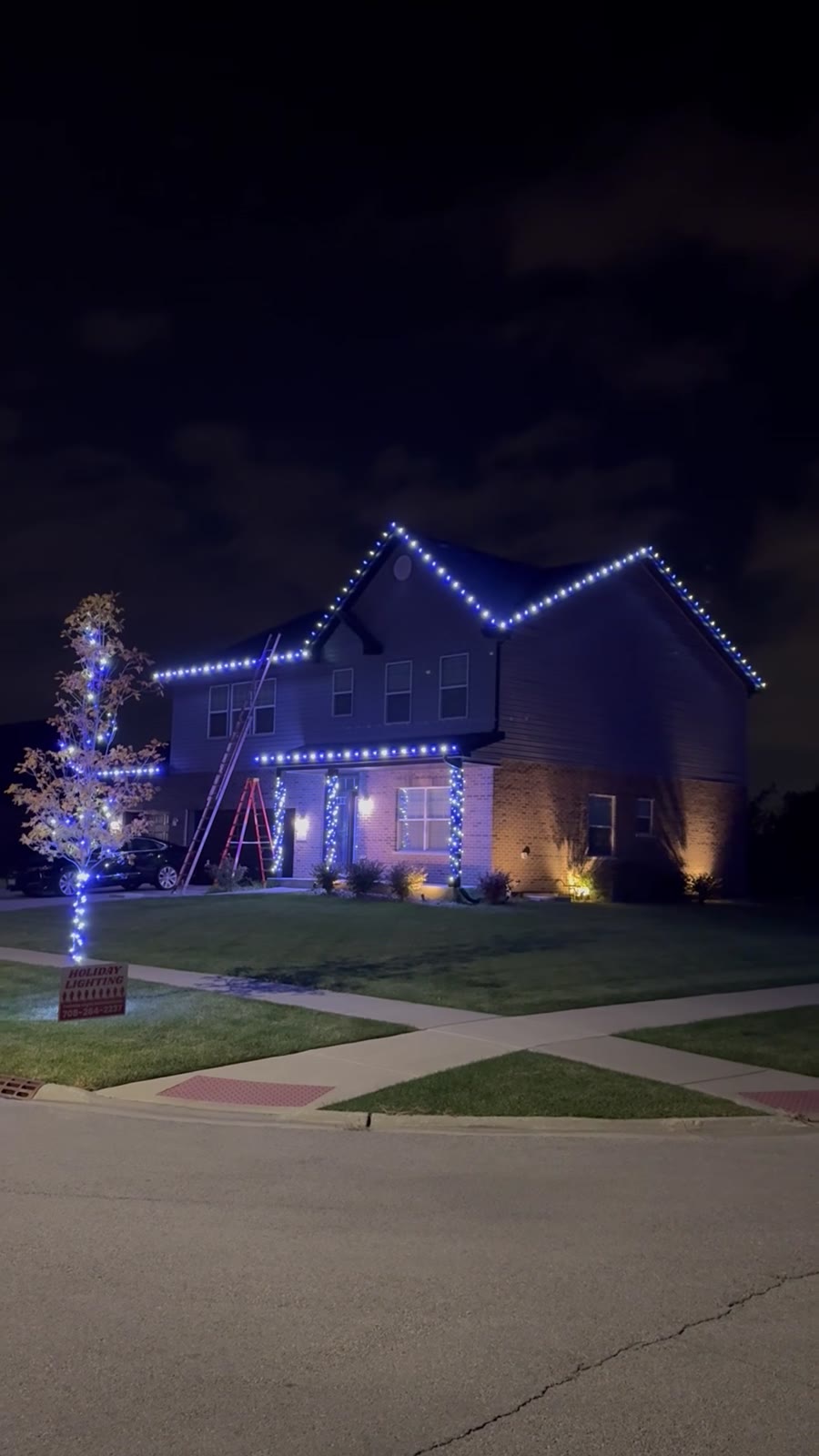 Home glowing with a custom blue and white Christmas lighting scene